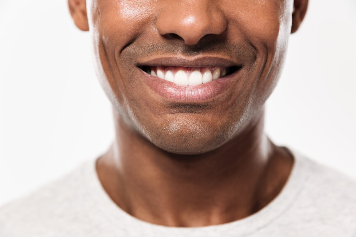 Preventive dental care : Image showing a smiling African young man