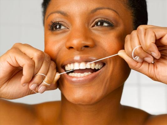 Preventive dental care : Image showing woman flossing teeth